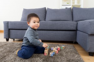 image of boy playing on rug for Sydney residential rug cleaning service from Green Clean Carpet Cleaning